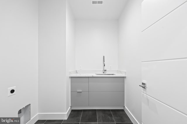 4810 3rd St N, Arlington, VA 22203 - washroom with hookup for an electric dryer and dark tile patterned floors