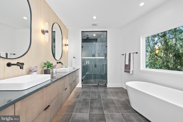 4810 3rd St N, Arlington, VA 22203 - bathroom featuring a stall shower, tile patterned flooring, double vanity, a freestanding bath, and recessed lighting