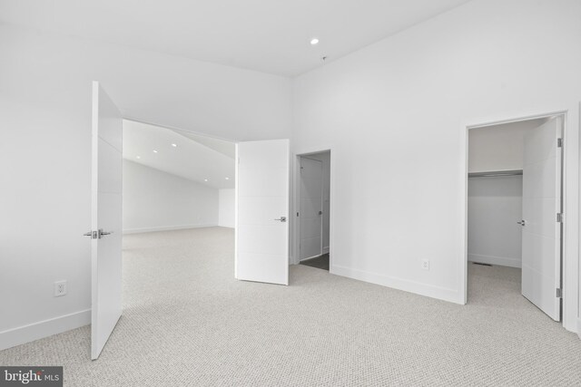 4810 3rd St N, Arlington, VA 22203 - unfurnished bedroom featuring light colored carpet, a walk in closet, recessed lighting, and a closet