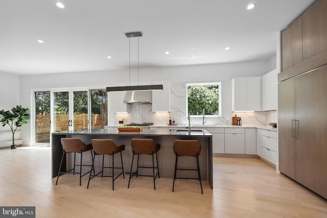 4810 3rd St N, Arlington, VA 22203 - kitchen with modern cabinets, tasteful backsplash, recessed lighting, light wood-type flooring, and a center island with sink