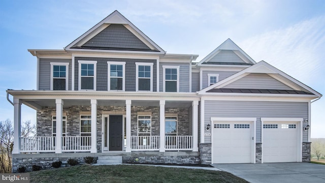 craftsman inspired home featuring driveway, stone siding, an attached garage, a standing seam roof, and a porch