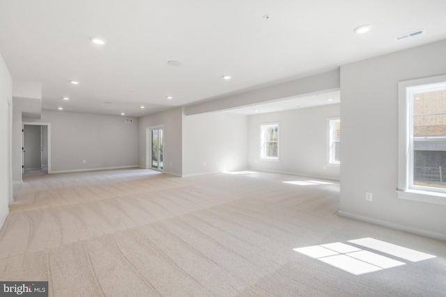 interior space featuring recessed lighting, light carpet, visible vents, and baseboards