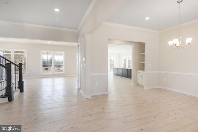 interior space with light wood finished floors, stairway, an inviting chandelier, ornamental molding, and baseboards