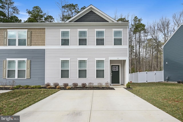 view of front of property featuring fence and a front lawn