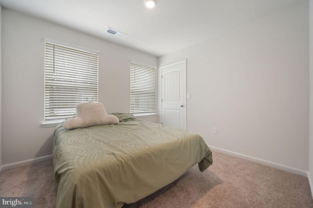 bedroom with carpet, visible vents, and baseboards