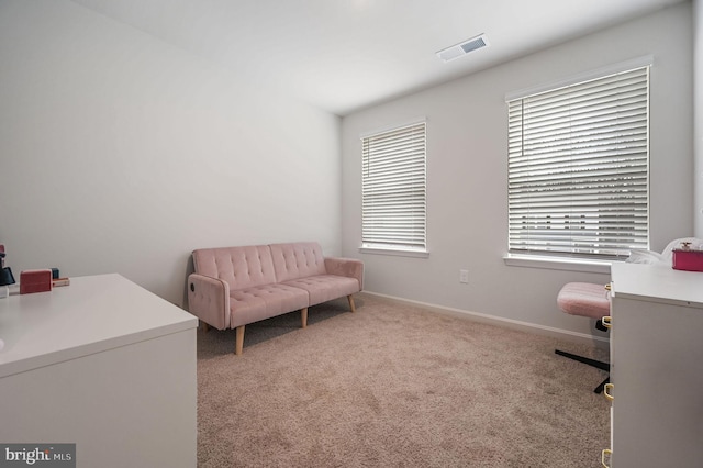 sitting room with carpet, visible vents, and baseboards