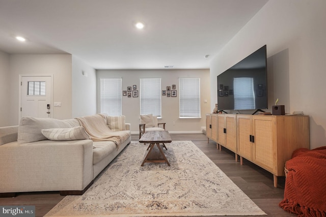 living room featuring baseboards, dark wood-style flooring, and recessed lighting