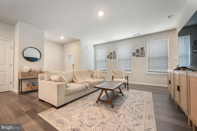 living room with dark wood-style floors, baseboards, visible vents, and recessed lighting