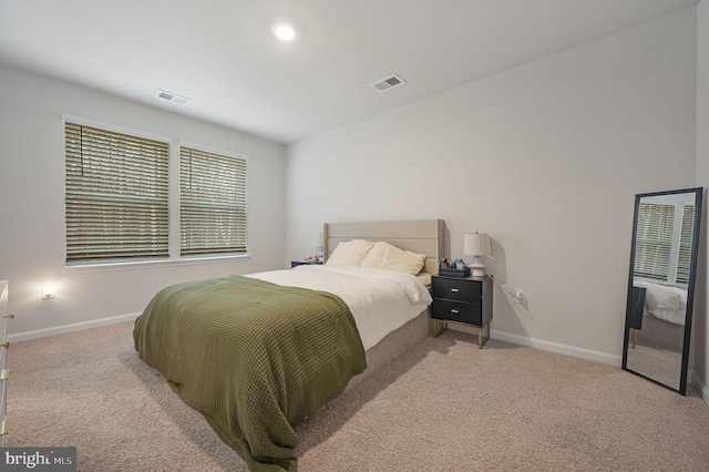 carpeted bedroom featuring visible vents and baseboards