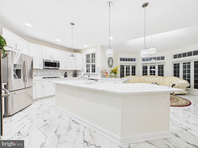 kitchen with marble finish floor, appliances with stainless steel finishes, backsplash, and recessed lighting