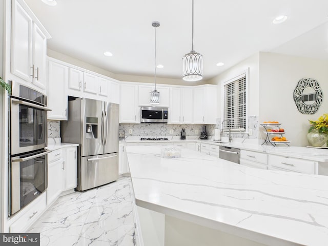 kitchen with white cabinets, decorative backsplash, appliances with stainless steel finishes, marble finish floor, and recessed lighting