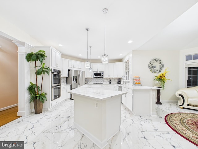 kitchen featuring stainless steel appliances, marble finish floor, a sink, and decorative backsplash