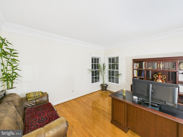 home office with light wood-type flooring, crown molding, and baseboards