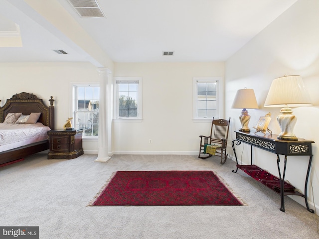 carpeted bedroom featuring baseboards, visible vents, and ornate columns