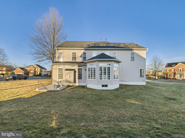 rear view of house with a yard