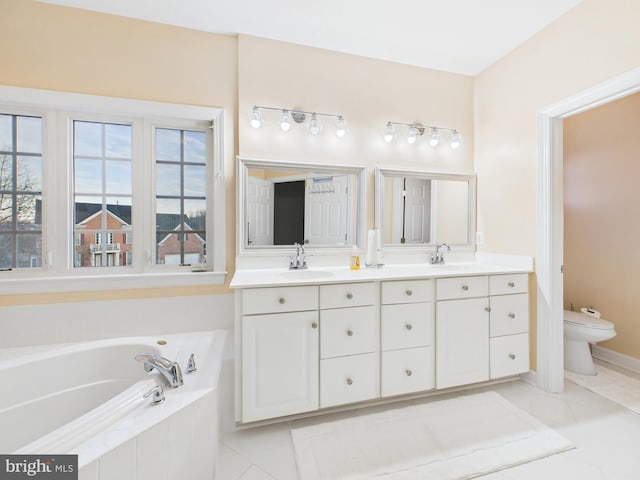 full bath featuring a bath, tile patterned flooring, double vanity, and a sink