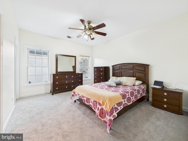 bedroom with ceiling fan, carpet flooring, and baseboards