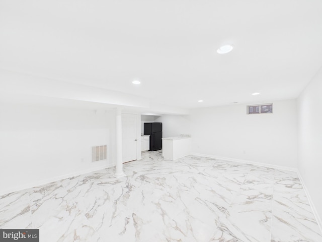 finished below grade area featuring recessed lighting, marble finish floor, visible vents, and baseboards