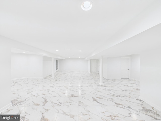 finished basement featuring marble finish floor, recessed lighting, and baseboards