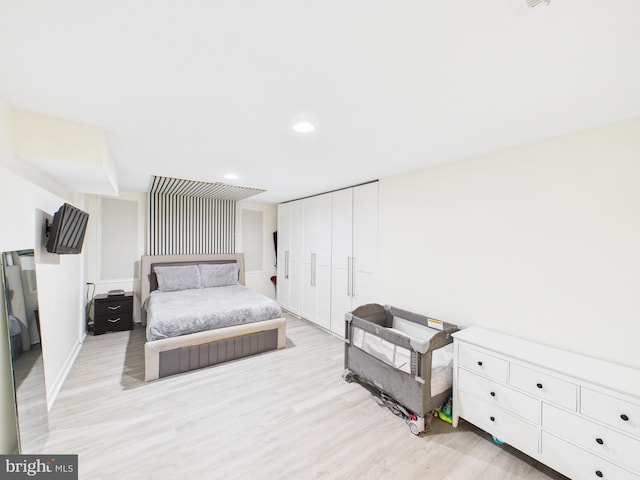 bedroom featuring recessed lighting, a closet, and light wood finished floors