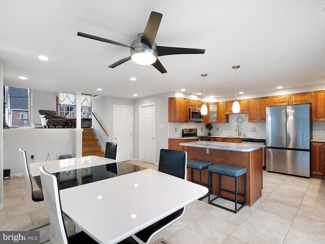 dining space featuring ceiling fan, light tile patterned floors, stairway, and recessed lighting