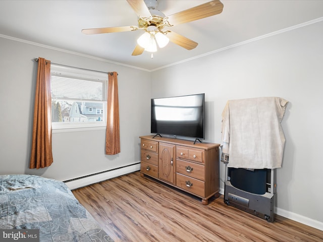 bedroom with ceiling fan, light wood finished floors, a baseboard radiator, and crown molding