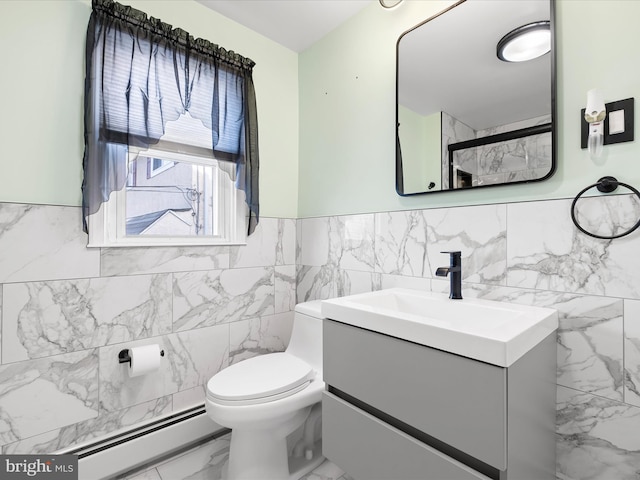 bathroom with wainscoting, toilet, marble finish floor, vanity, and a baseboard heating unit