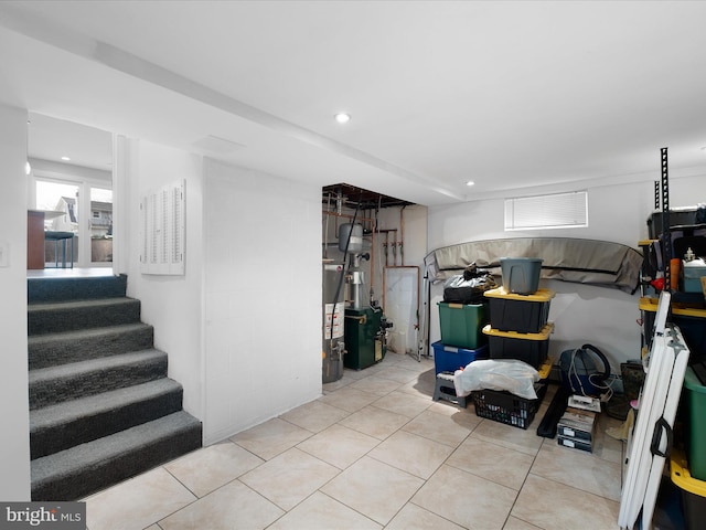 basement with tile patterned floors, recessed lighting, and stairs