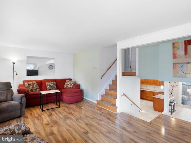 living room with stairs and light wood-style floors