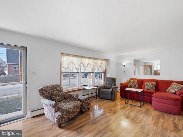 living room featuring a baseboard radiator, baseboard heating, and wood finished floors