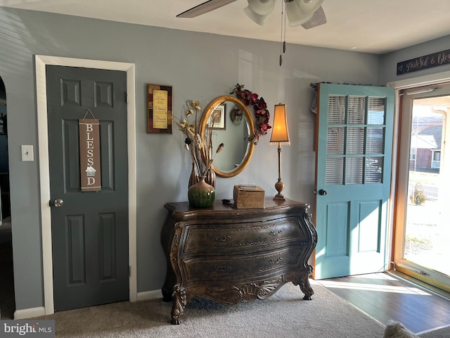 foyer featuring ceiling fan and baseboards