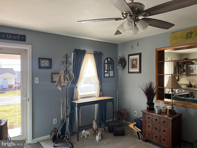 interior space featuring carpet, a ceiling fan, and baseboards