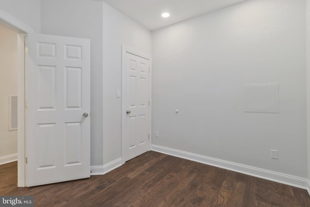 interior space featuring dark wood-style floors, baseboards, and visible vents