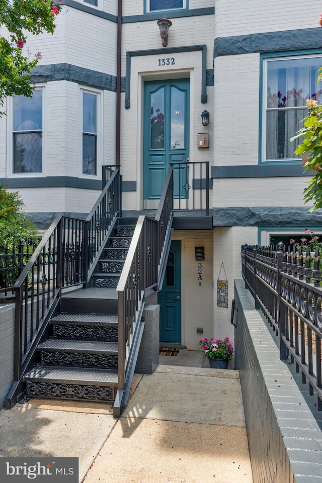 view of exterior entry with brick siding