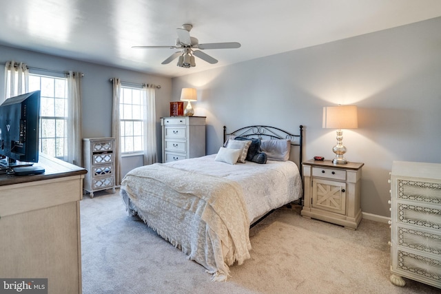 carpeted bedroom with a ceiling fan and baseboards