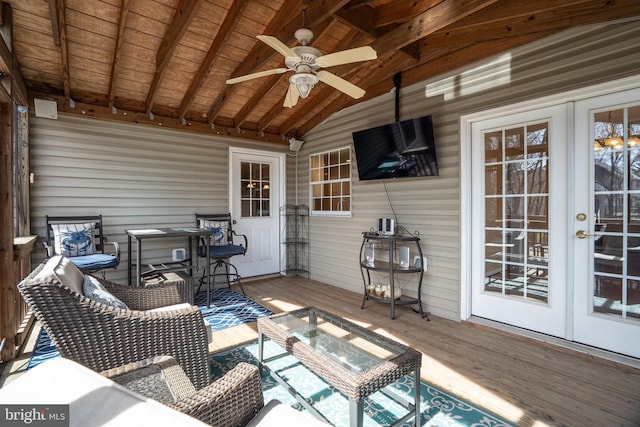 wooden terrace with a ceiling fan and french doors