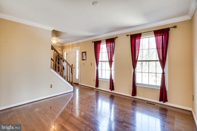 entryway featuring a wealth of natural light, hardwood / wood-style floors, and ornamental molding