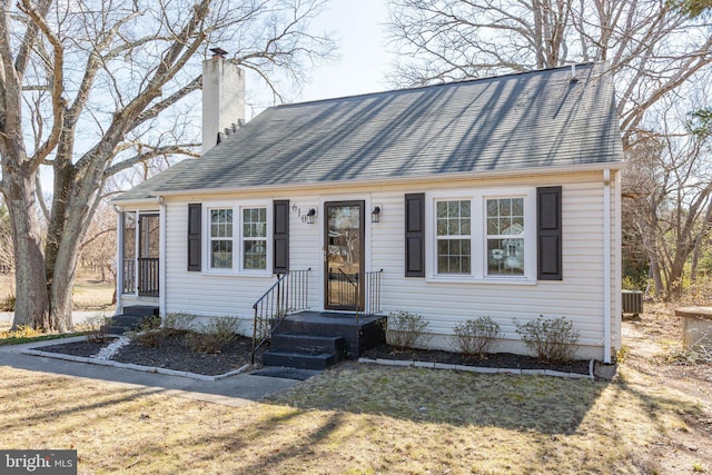 view of front of property with central AC unit and a chimney