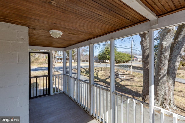 unfurnished sunroom with wooden ceiling and plenty of natural light