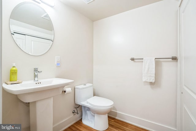 5664 Gainor Rd, Philadelphia, PA 19131 - bathroom featuring a sink, wood finished floors, toilet, and baseboards