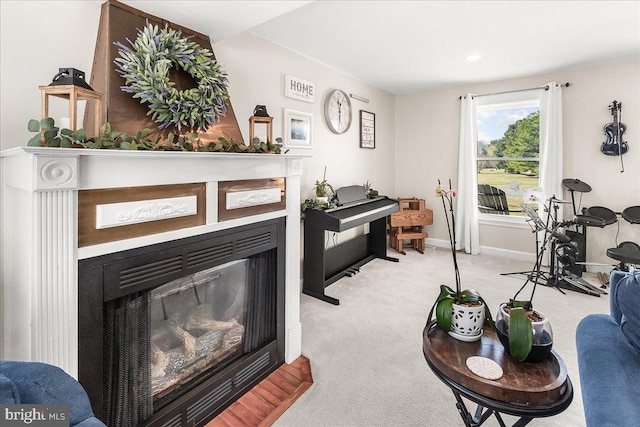 living room featuring carpet flooring, a fireplace, and baseboards