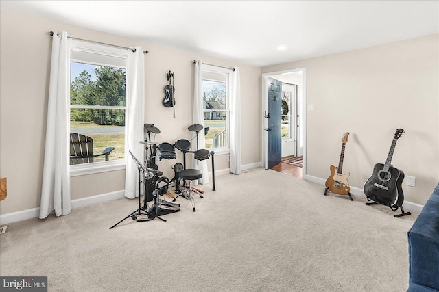 workout room featuring baseboards and carpet floors