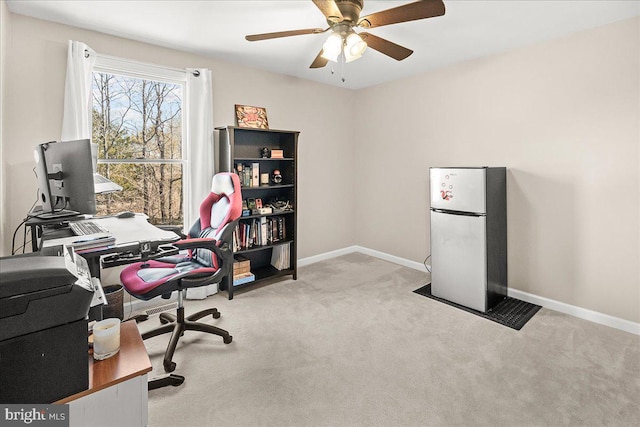 office space with carpet flooring, a ceiling fan, and baseboards