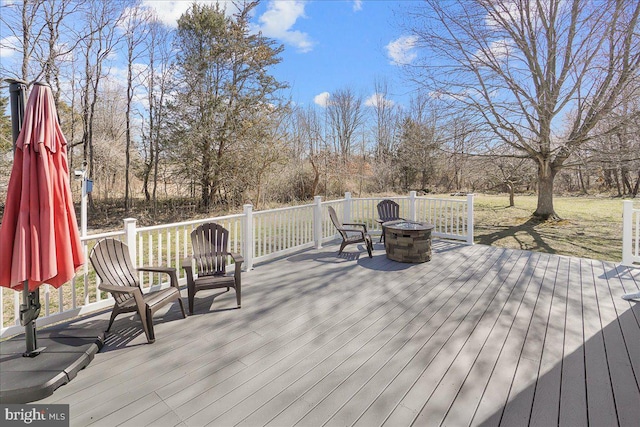 wooden terrace featuring a fire pit