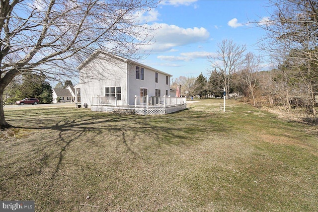 exterior space with a deck and a lawn