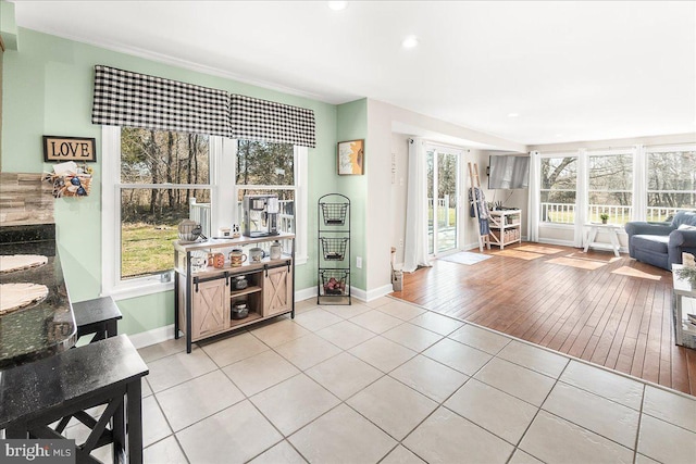 living area with light tile patterned floors, baseboards, and recessed lighting