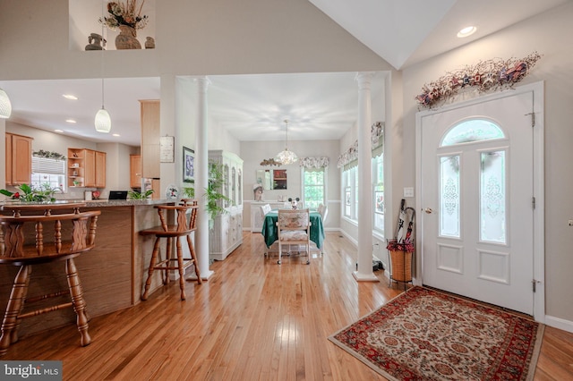 17024 Turtle Hl, Milford, DE 19963 - entrance foyer featuring light wood-style flooring, recessed lighting, baseboards, decorative columns, and vaulted ceiling
