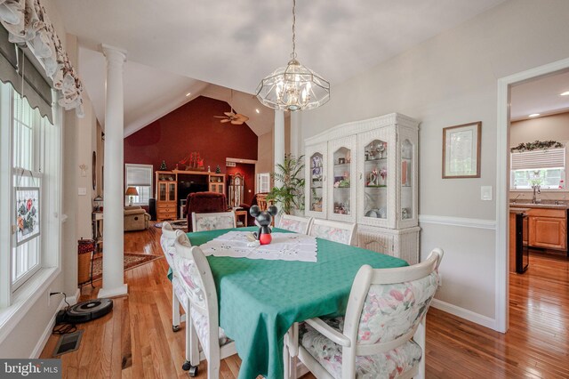 17024 Turtle Hl, Milford, DE 19963 - dining space with light wood finished floors, ceiling fan with notable chandelier, baseboards, ornate columns, and visible vents
