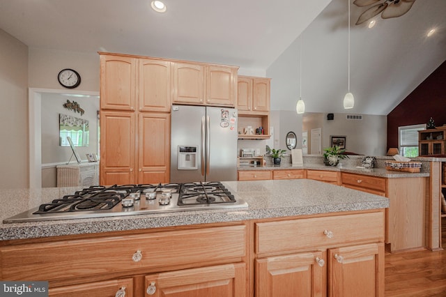 17024 Turtle Hl, Milford, DE 19963 - kitchen with a peninsula, light brown cabinetry, lofted ceiling, and stainless steel appliances