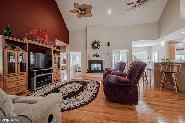 17024 Turtle Hl, Milford, DE 19963 - living room with light wood finished floors, ceiling fan, a multi sided fireplace, and high vaulted ceiling
